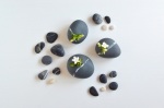 Ceramic vases in shape of black pebbles. By Otchipotchi.